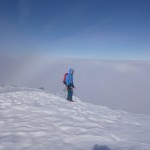 Climber above the clouds, having climbed Smith's Route